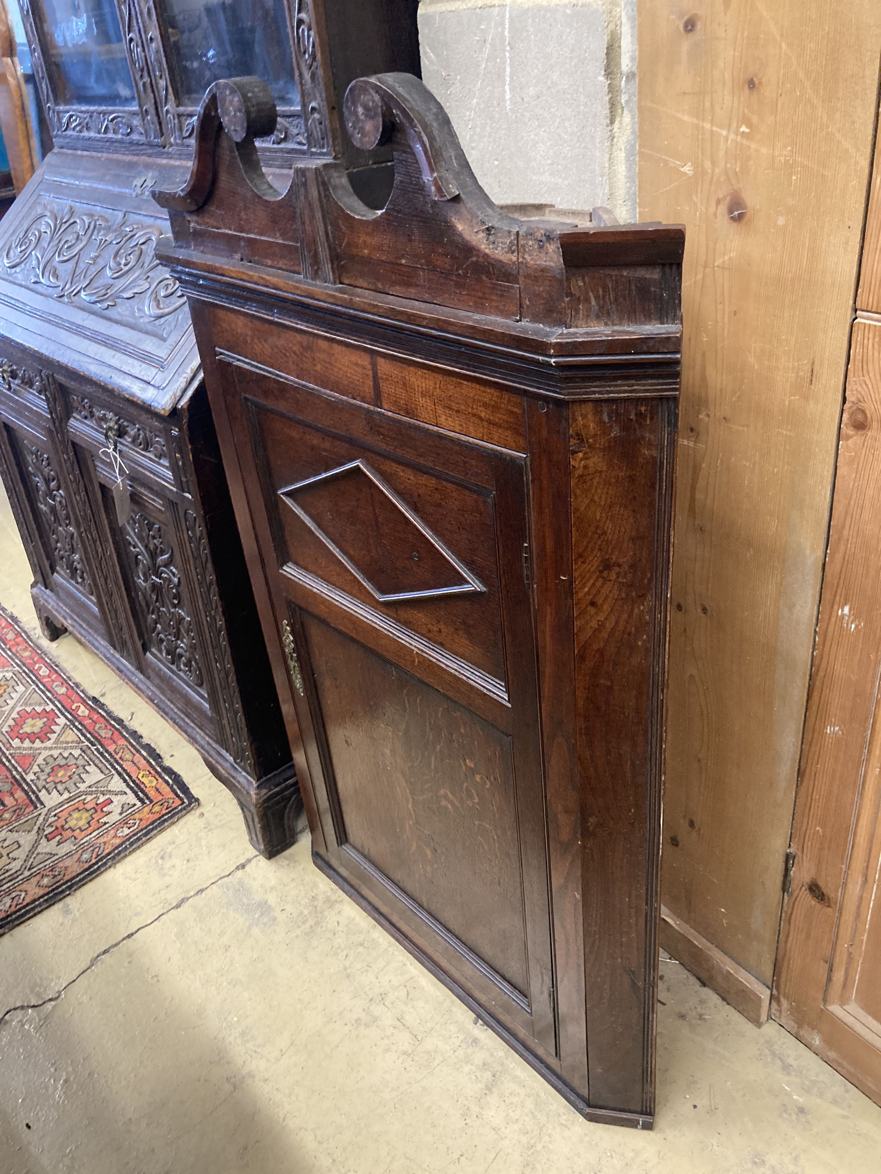 A George III oak hanging corner cabinet, width 72cm, depth 36cm, height 110cm